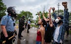 Minneapolis police officers faced off with protesters outside the Third Precinct station on May 26. Morale has plummeted in the department since the F