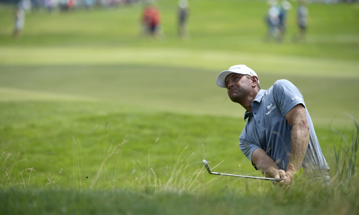 Lucas Glover hit out of the rough on the18th hole during the final day of the 3M Open at TPC Twin Cities.