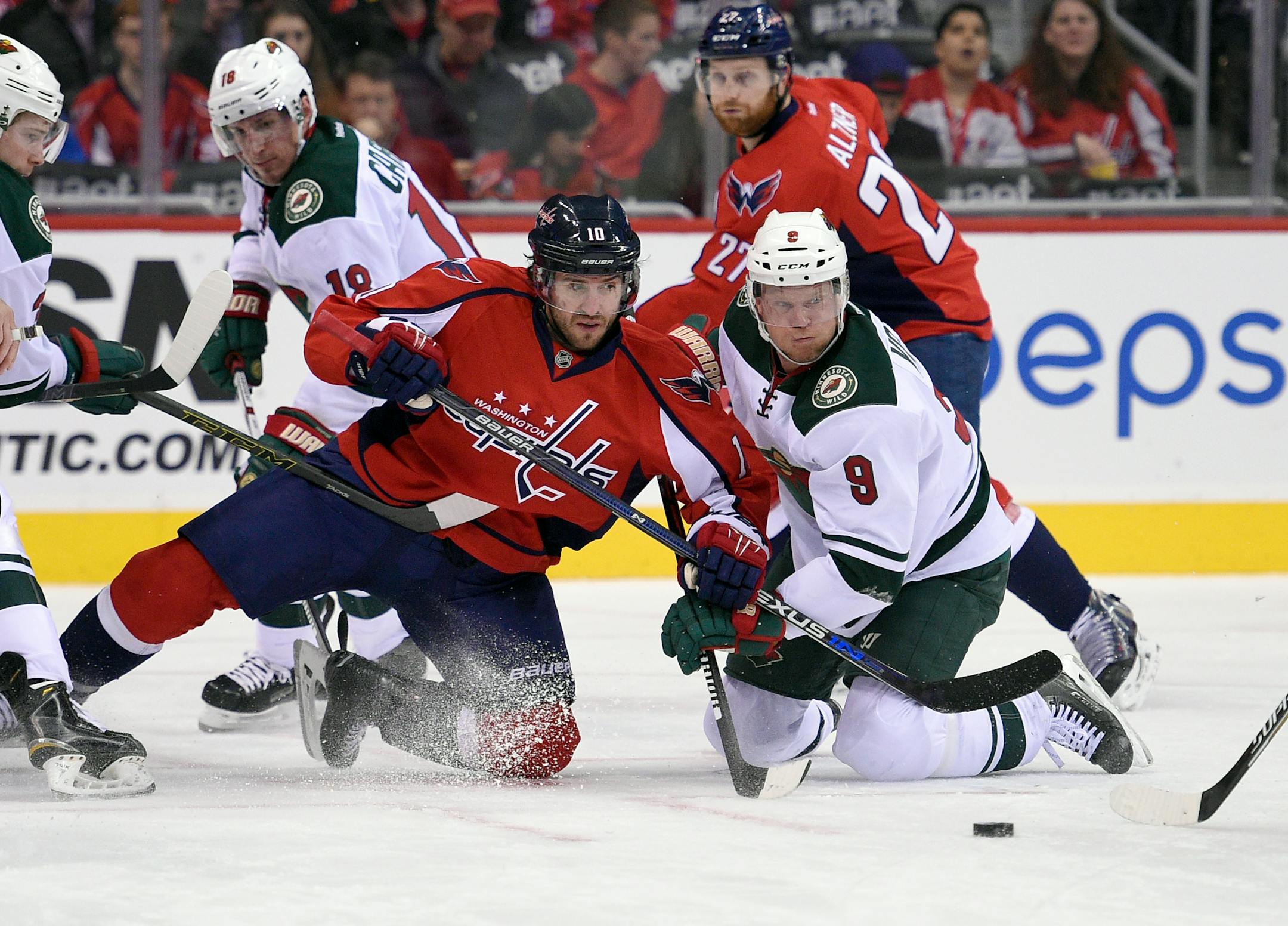 Washington Capitals center Mike Richards (10) battles for the puck against Minnesota Wild center Mikko Koivu (9), of Finland, during the first period of an NHL hockey game Friday, Feb. 26, 2016, in Washington. (AP Photo/Nick Wass)