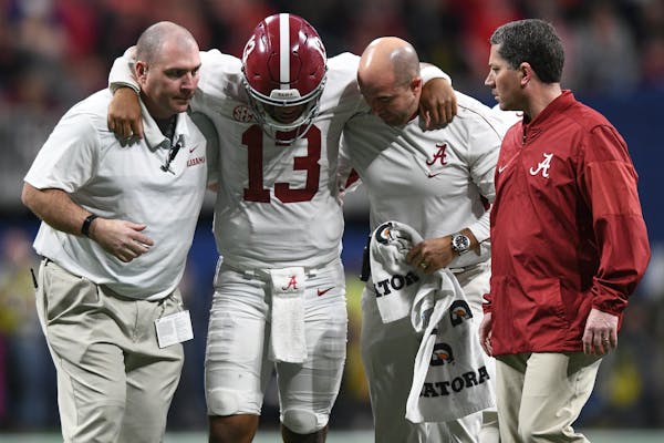 Alabama quarterback Tua Tagovailoa (13) comes off the field with an injury during an NCAA college football game against Georgia for the Southeastern C