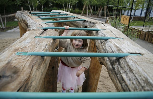 Maren Vegoe pushed herself to conquer the monkey bars, despite the fact the rungs were wet from rain. The outdoor play area at the Child Development C