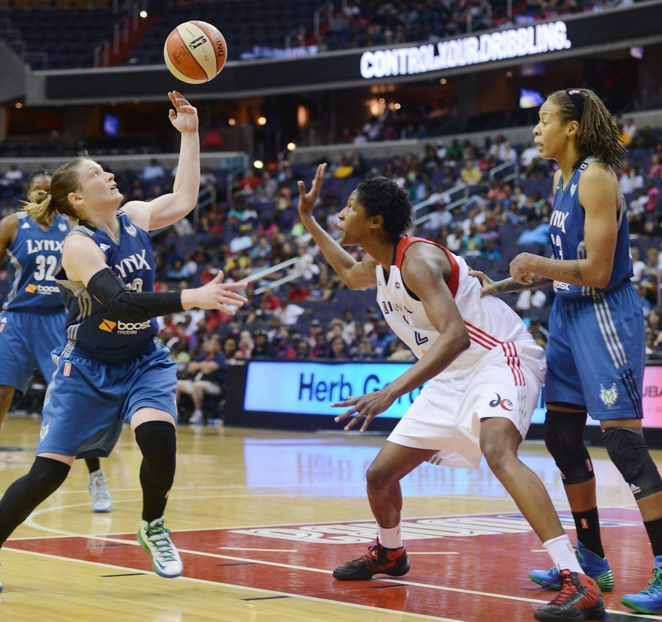 Lynx guard Lindsay Whalen reaches for the ball after she knocked it away from Washington Mystics center Michelle Snow on Saturday, June 8, 2013. The Mystics defeated the Lynx, 85-80.