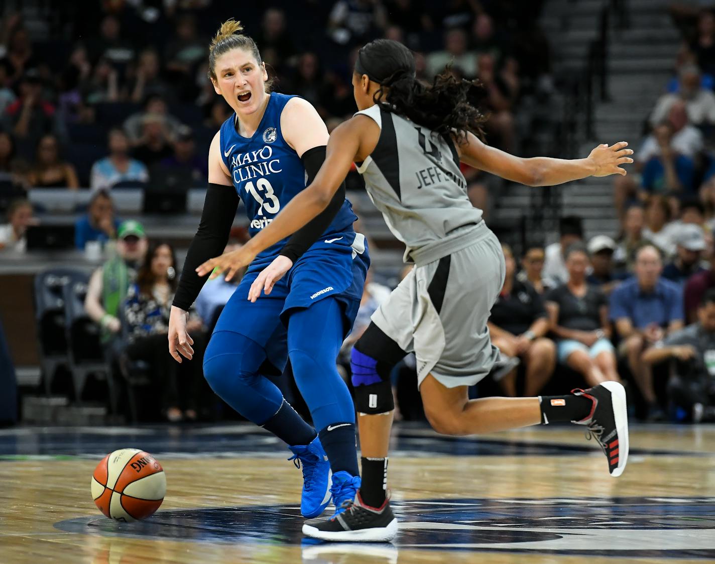 Minnesota Lynx guard Lindsay Whalen (13) directs her teammates while moving the ball down the court under pressure from Las Vegas Aces guard Moriah Jefferson in the first half on Friday, July 13, 2018, at Target Center in Minneapolis. (Aaron Lavinsky/Minneapolis Star Tribune/TNS)