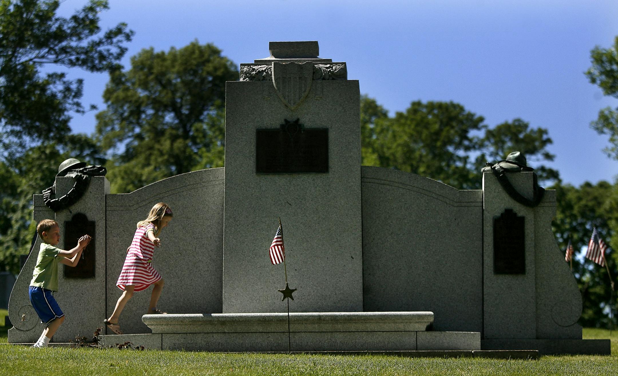 Sullivan Leier, 7, and his sister Ellen Leier, 5, of Minneapolis ventured onto the Soldiers Memorial during a ceremony at Lakewood Cemetry. They were there with their father Tom Leier.