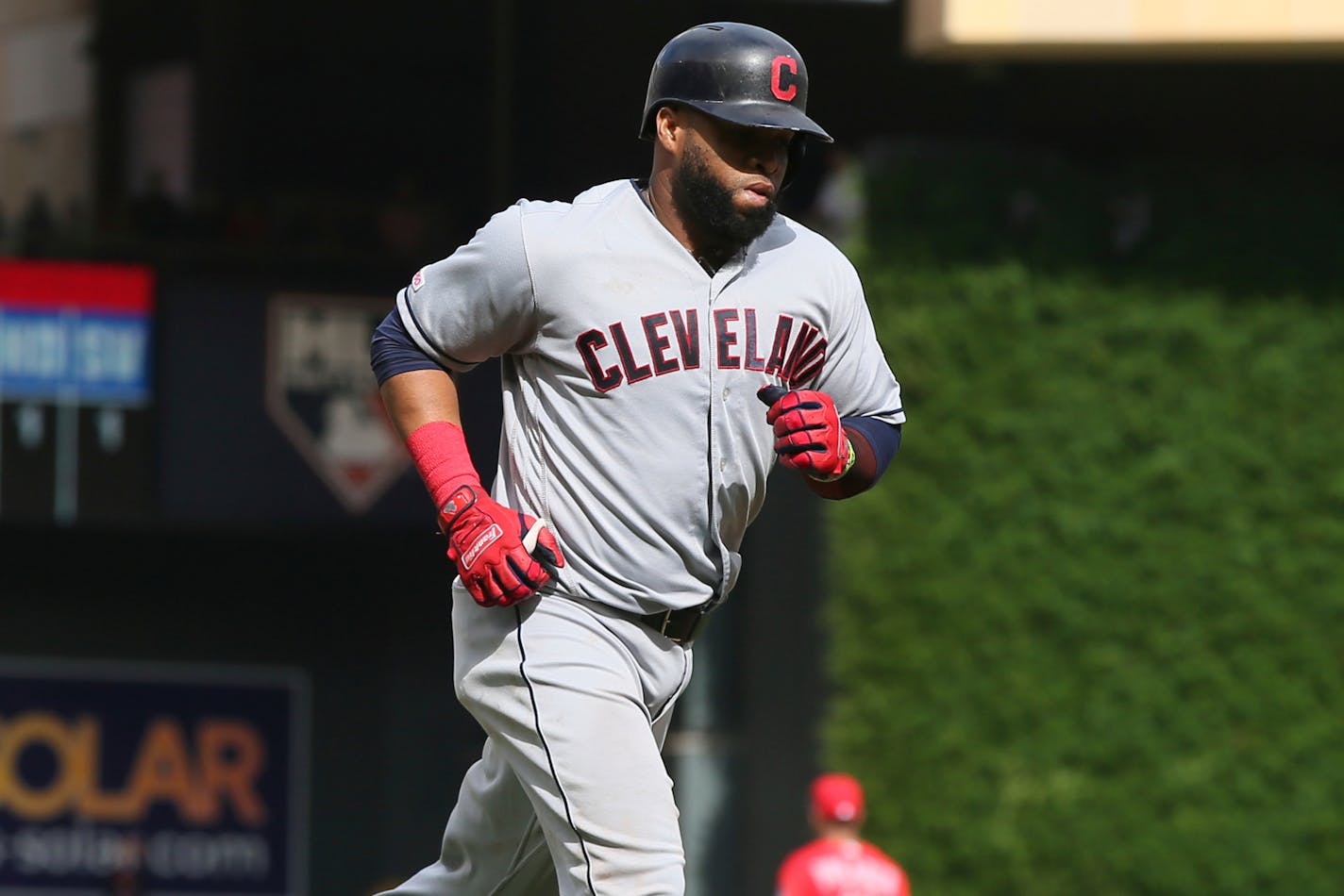 Cleveland Indians' Carlos Santana jogs home on a grand slam against the Minnesota Twins in a baseball game Sunday, Aug. 11, 2019, in Minneapolis. (AP Photo/Jim Mone)