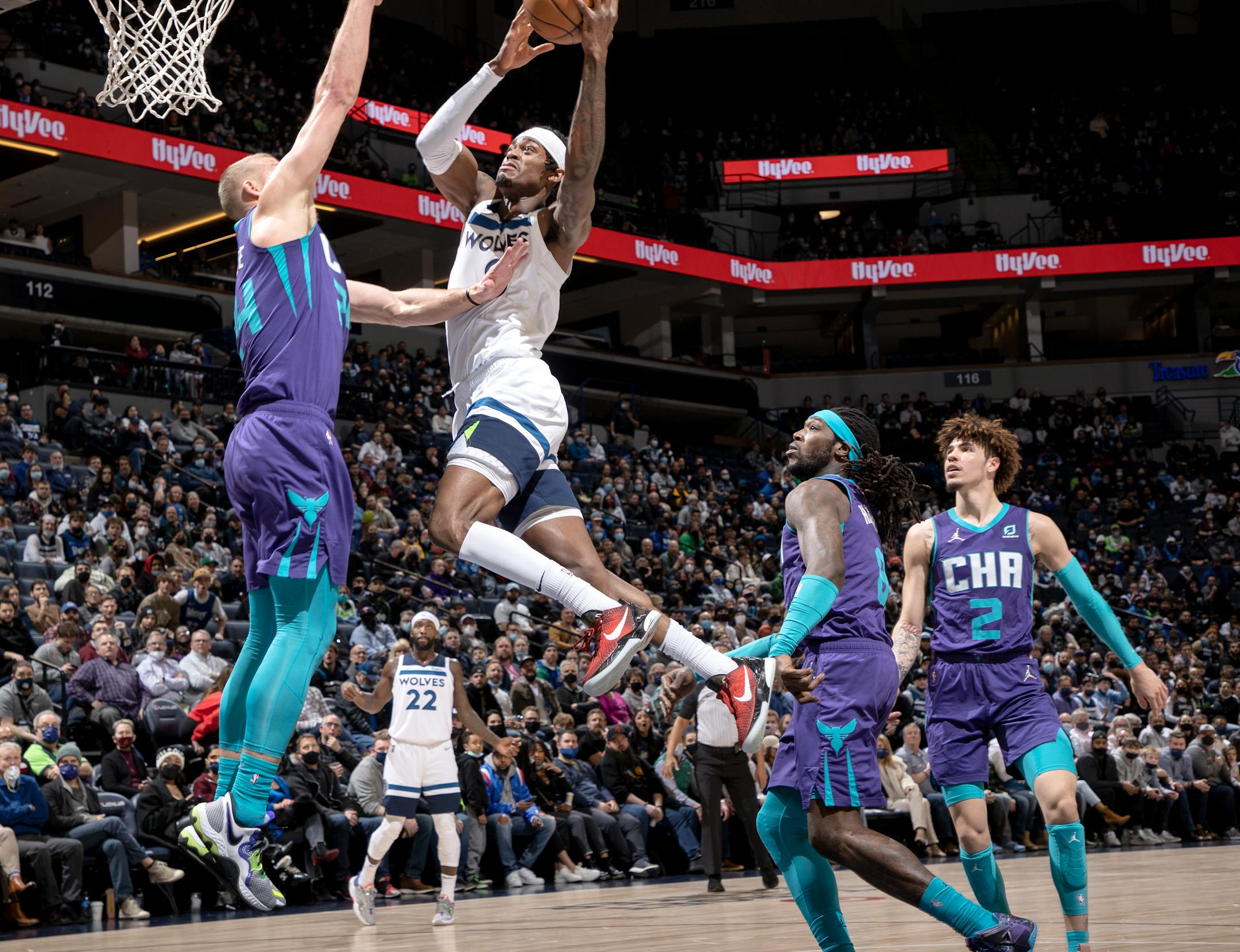 Jarred Vanderbilt (8) of the Minnesota Timberwolves is defended by Mason Plumlee (24) of the Charlotte Hornets in the first quarter.