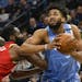 Minnesota Timberwolves center Karl-Anthony Towns, right, drives past Houston Rockets guard James Harden during the first half of an NBA basketball gam