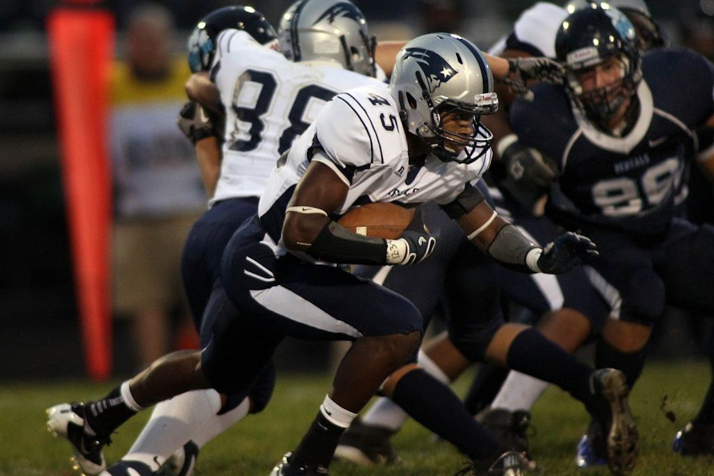 Champlin Park running back Michael Sales battled for a short gain in a game in September.