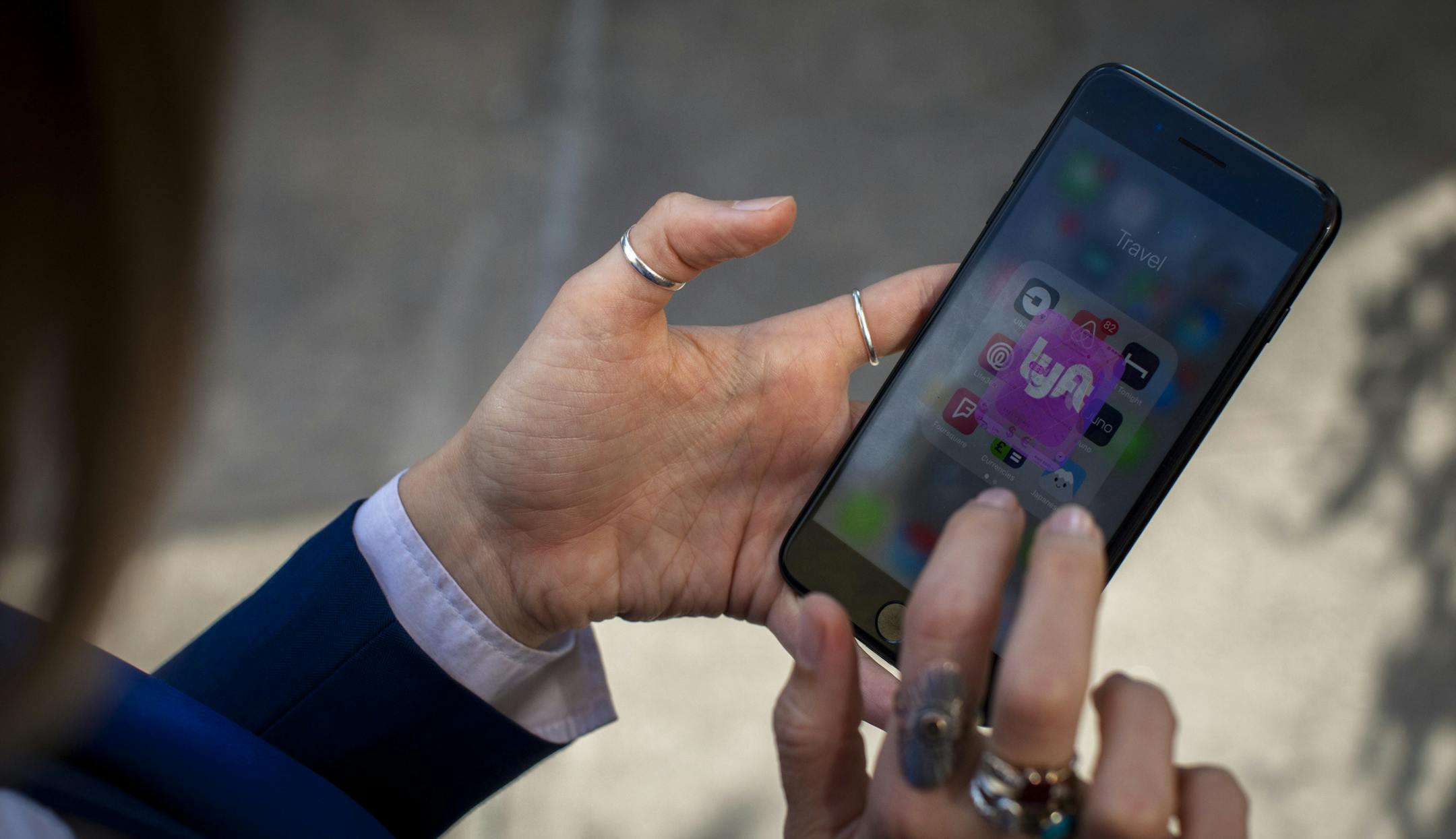 FILE -- A Lyft user requests a ride from the phone app, in New York, June 4, 2018. With its number of passengers and trip fees growing, the ride-hailing company in August 2019 said its losses would not be as bad as it previously thought. (Dave Sanders/The New York Times)