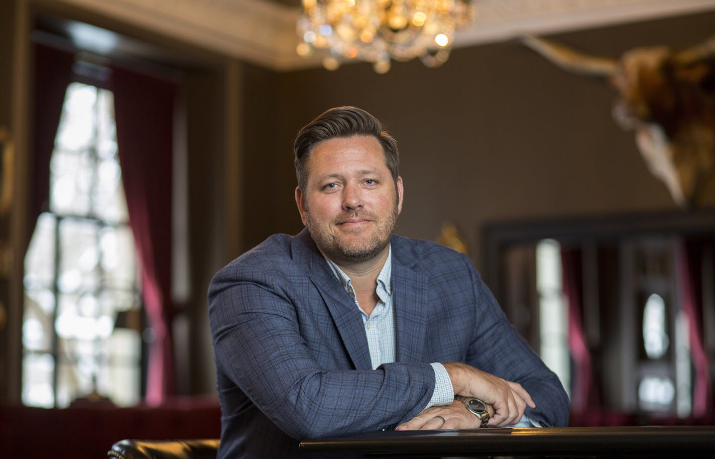 In this Feb. 11, 2020, photo, Brent Frederick, founder of Jester Concepts, a restaurant group in Minneapolis poses at P.S. Steak. Frederick puts a 3% voluntary surcharge on guest checks to help pay for health insurance and mental health services and says almost all guests agree to pay it. (AP Photo/Andy Clayton-King) ORG XMIT: MNAK102