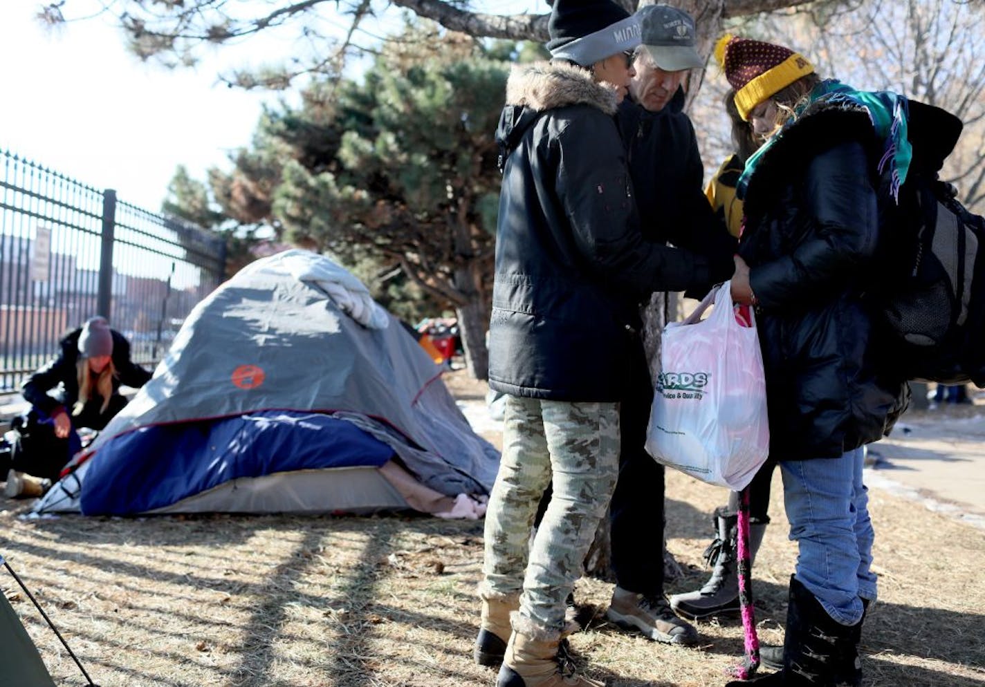 St. Paul officials began clearing out the St. Paul homeless near the Cathedral of St. Paul Wednesday, Nov. 15, 2018, in St. Paul, MN. Here, a woman named Jolee (no last name), right, held hands with homeless advocates as they prayed together before an emotional Jolee packed up her stuff to head to the homeless encampment in Minneapolis.