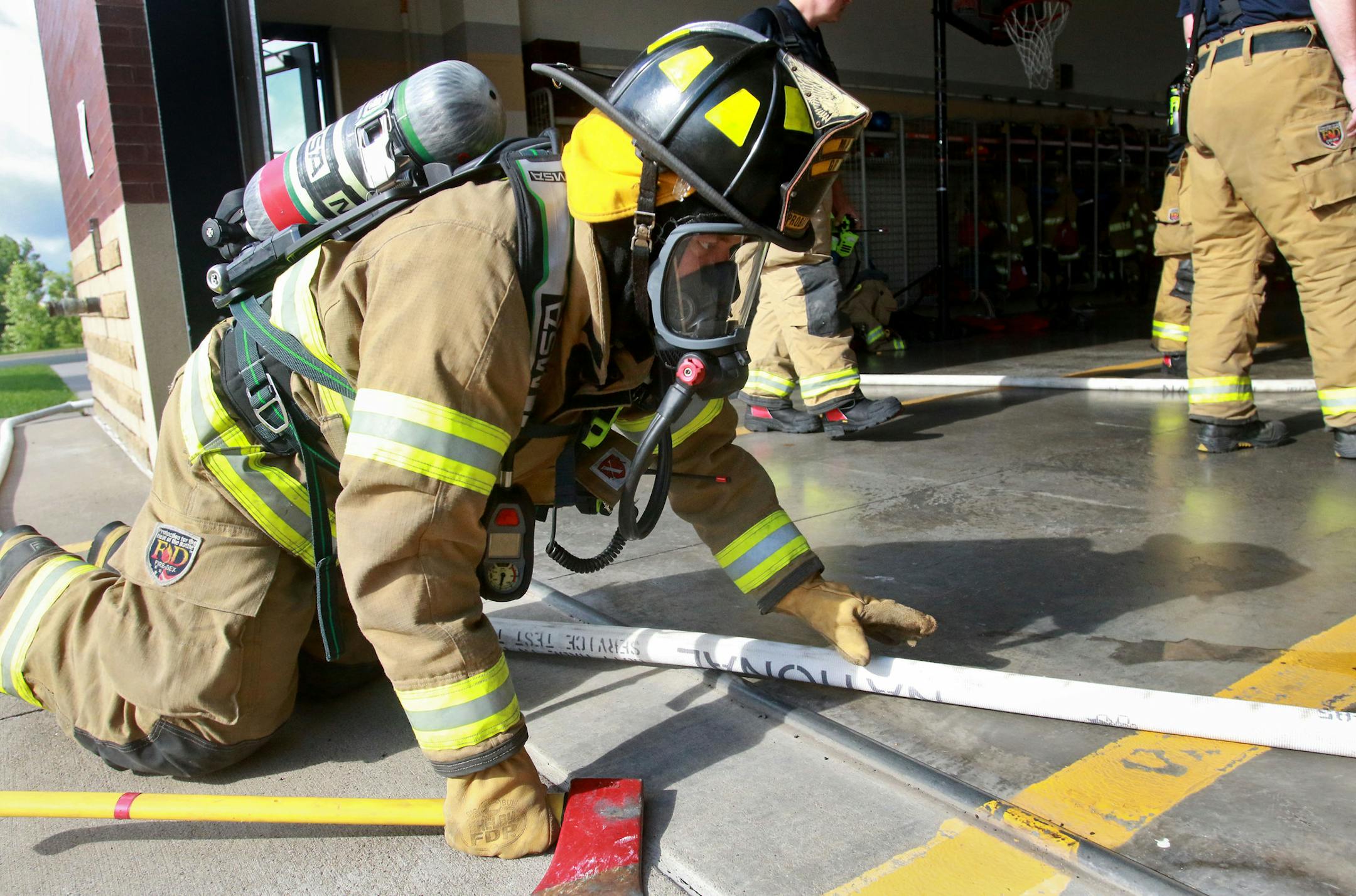 Maple Grove firefighters, including recent graduates from the academy, partook in a confidence course as part of their monthly training. The class is a mix of current paid on call firefighters, recent graduates and fire explorers. Firefighters and prospective ones went through a hose maze and an obstacle course while carrying a ventilation fan, air packs and radios. Here, Steve James, a Maple Grove probationary firefighter, went through a hose maze during the training at Station 5 Wednesday, Jun
