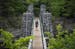 A man carried his child on his back while crossing the swinging bridge at Jay Cooke State Park on Wednesday.