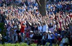 Fans celebrated after Rory McIlroy's ball went into the water Saturday on the 16th hole during the afternoon four-ball matches at the Ryder Cup.