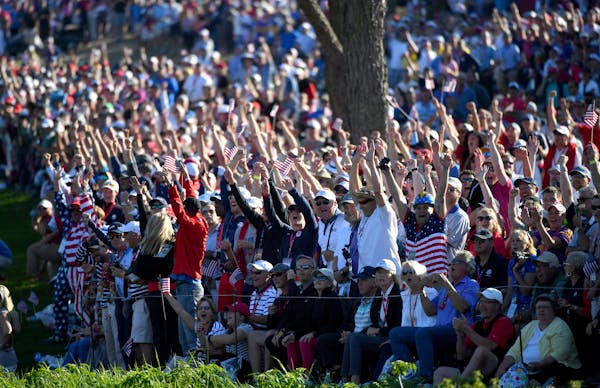 Fans celebrated after Rory McIlroy's ball went into the water Saturday on the 16th hole during the afternoon four-ball matches at the Ryder Cup.