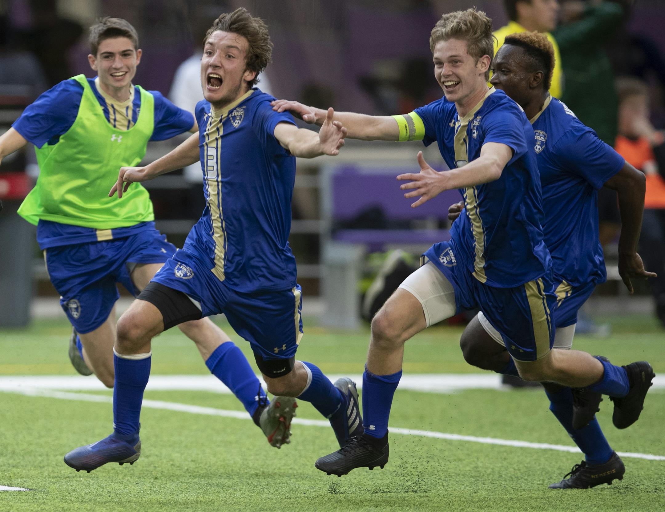Noah Hermanson left, of Holy Angels and teammate Conor O’Rourke dashed across the field with teammates after scoring the the winning goal in double over time. Holy Angels beat Blake 3-2.] Jerry Holt • Jerry.holt@startribune.com Class 1A boys championship Holy Angels beat Blake 3-2 in double overtime at U.S. Bank Stadium Thursday Oct. 31, 2019. in Minneapolis, MN. Jerry Holt