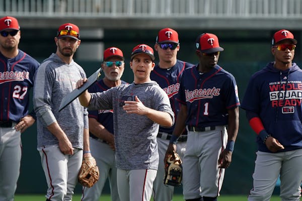 Minnesota Twins Major League advance scout Frankie Padulo gave directions to position players during the first day of full squad workouts Monday.