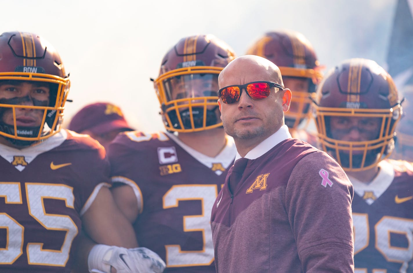 Minnesota Gophers players wait with head coach P.J. Fleck to run out of the tunnel before their game against the Purdue Boilermakers Saturday, Oct. 1, 2022 at Huntington Bank Stadium in Minneapolis, Minn. ]