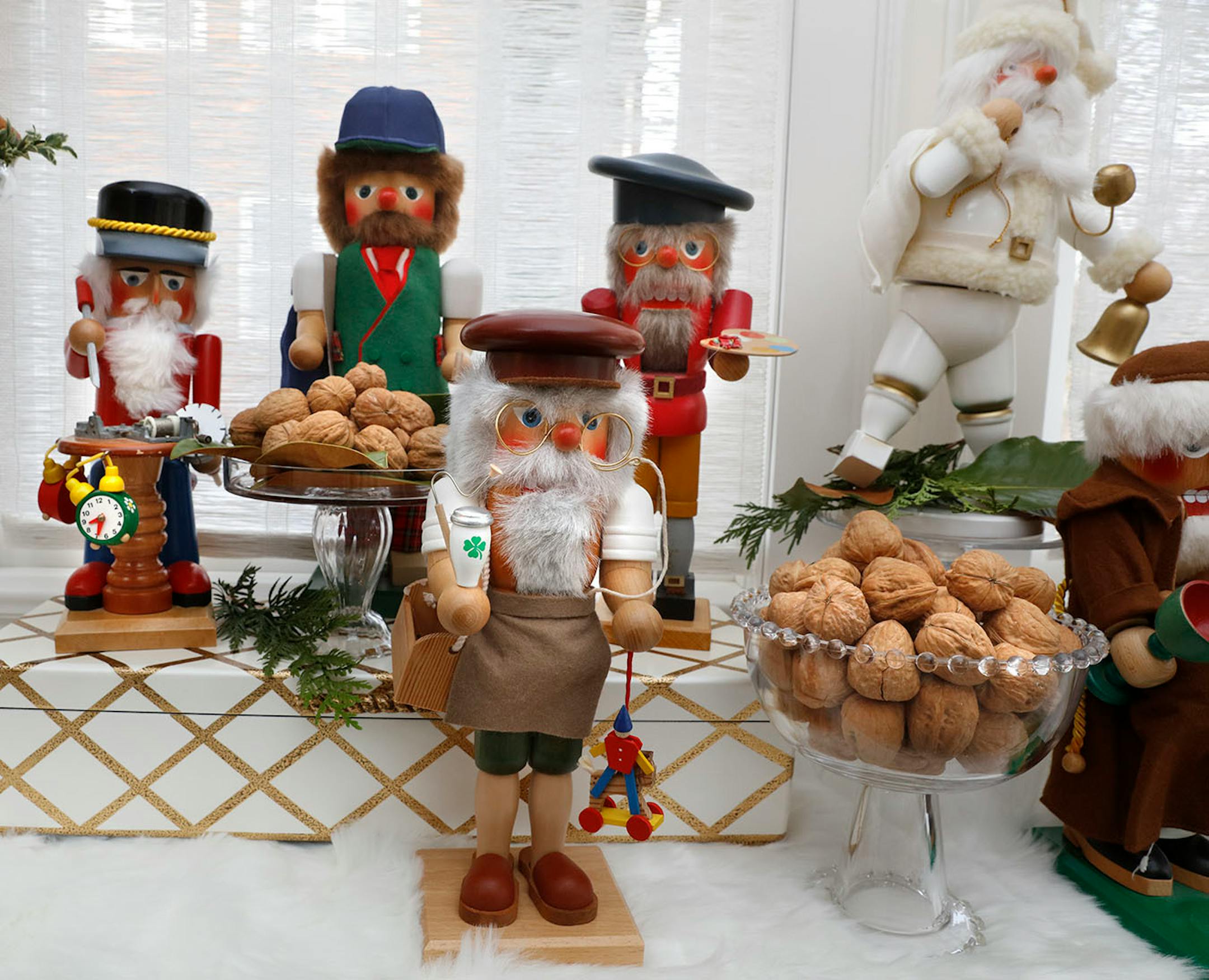 Place nutcrackers on decorative boxes or glass cake stands to create a variety of heights for visual interest.