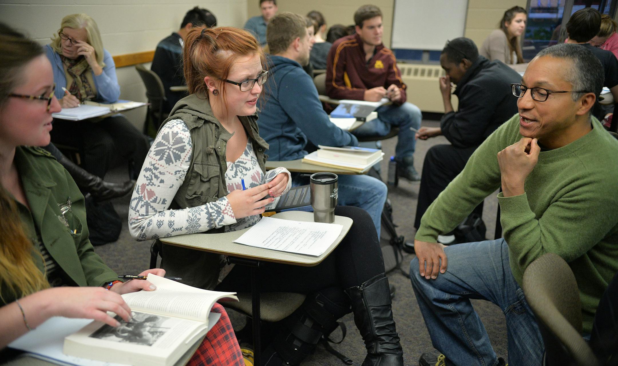 Professor David Pellow speaks with students Colleen Lomenick (center) and Anika Johnson (left) as they discuss class reading in small groups in Sociology 4305: Society and the Environment Wednesday, October 8 at the University of Minnesota's Blegan Hall. Pellow is one of few union activists willing to speak publicly about the organizing effort at the U of M. ] (SPECIAL TO THE STAR TRIBUNE/BRE McGEE) **David Pellow (Sociology professor University of Minnesota, green sweater), Colleen Lomenick (ce