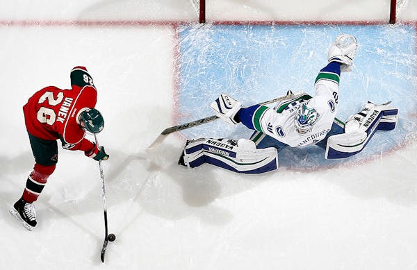 Wild winger Thomas Vanek prepared to shoot the puck past Canucks goalie Ryan Miller (30) for a goal in the first period Tuesday.