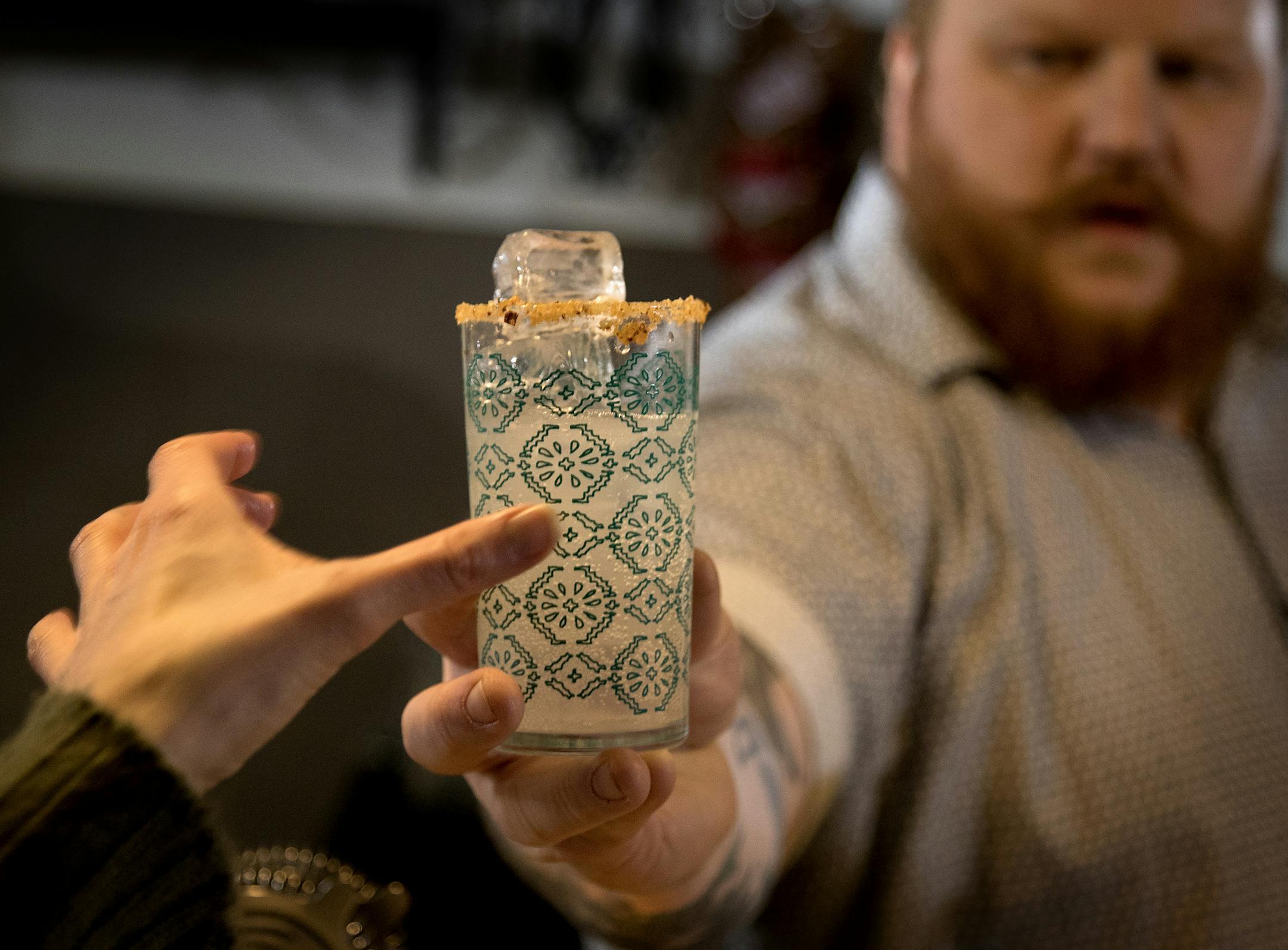 Nick Kosevich passed out a "Hecho en Mexico" during a cocktail making class at Lawless Distilling Company. ] CARLOS GONZALEZ ï cgonzalez@startribune.com - January 31, 2017, Minneapolis, MN, Seven years after founding a bitters company in Milwaukee, Bittercube has gained national attention for their products. Nick Kosevich and Marco Zappia are responsible for some of the hottest bar programs. Kosevich and Zappia will be leading a cocktail-making class at Lawless Distilling Company.