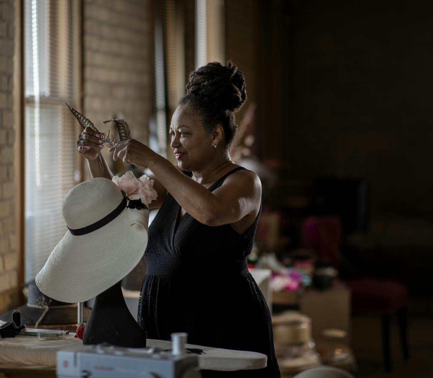 Angie Sandifer specializes in handmade women's custom hats from her St. Paul studio .] Jerry Holt •Jerry.Holt@startribune.com Angie Sandifer specializes in handmade women's custom hats from her St. Paul studio Wednesday July 79th , 2020 in St Paul ,MN.