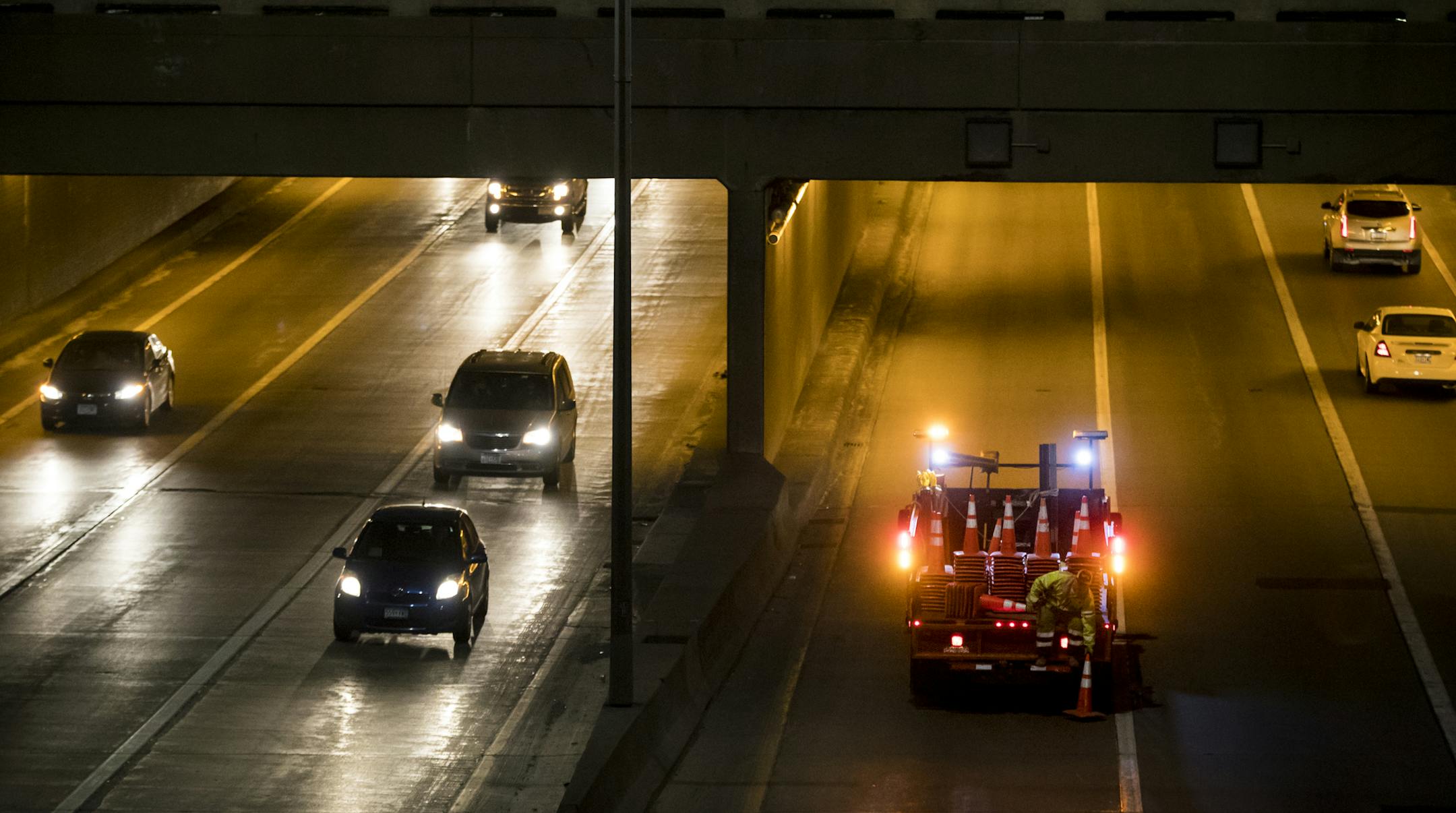 A man dropped safety cones on the road to shut down a lane of eastbound I-94 thru the Lowry Hill Tunnel Wednesday night in Minneapolis, Minn., on March 22, 2017. ] RENEE JONES SCHNEIDER &#x2022; renee.jones@startribune.com