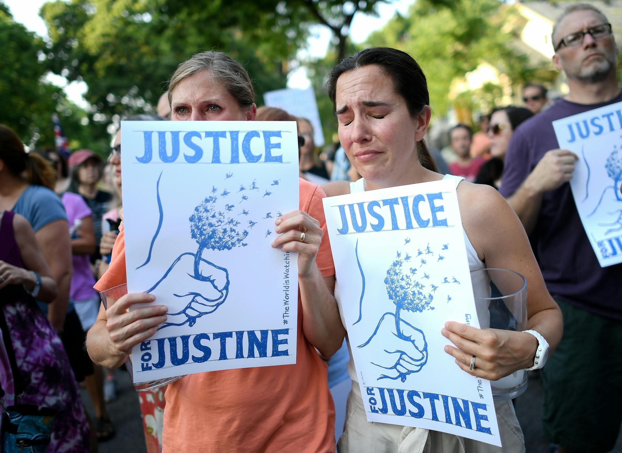 Chris, left, no last name given, and Betsy Custis were overcome with emotion during the start of the Peace and Justice March Thursday afternoon.