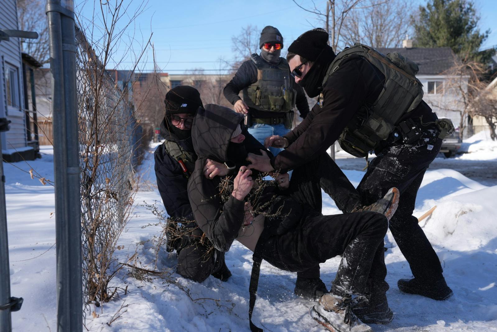 Federal agents tackle a person near 27th Street and 14th Avenue in Minneapolis on Feb. 3.