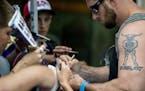 Vikings defensive lineman Brian Robison signed autographs for fans at the start of training camp.