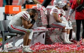 Ohio State players sit on the bench after their loss to Alabama in an NCAA College Football Playoff national championship game, Monday, Jan. 11, 2021,