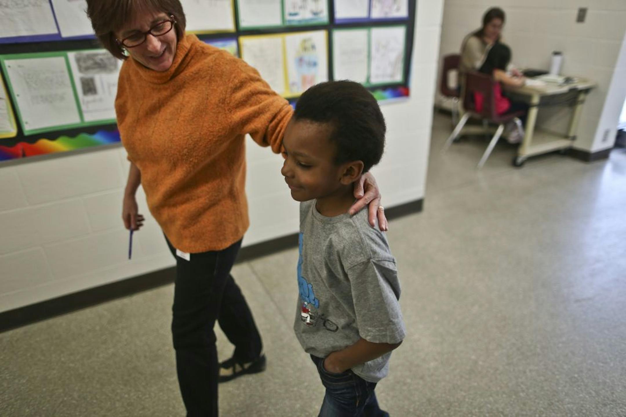 Dominic Caliguire, 8, walks with Learning Center teacher Betsy Braman through Frost Lake Magnet School hallways on Thursday, February 7, 2013 in St. Paul, Minn. Dominic was in the special education program and was gradually introduced to mainstream classrooms successfully. He has erratic behavior disorder but is pretty much in a full time class now and only goes to special ed at the end of the day.