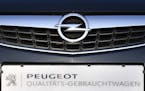 An Opel car with a sign reading 'quality second hand car' is offered for sale by a Peugeot dealer in Gelsenkirchen, Germany, Tuesday, Feb. 14, 2017. F