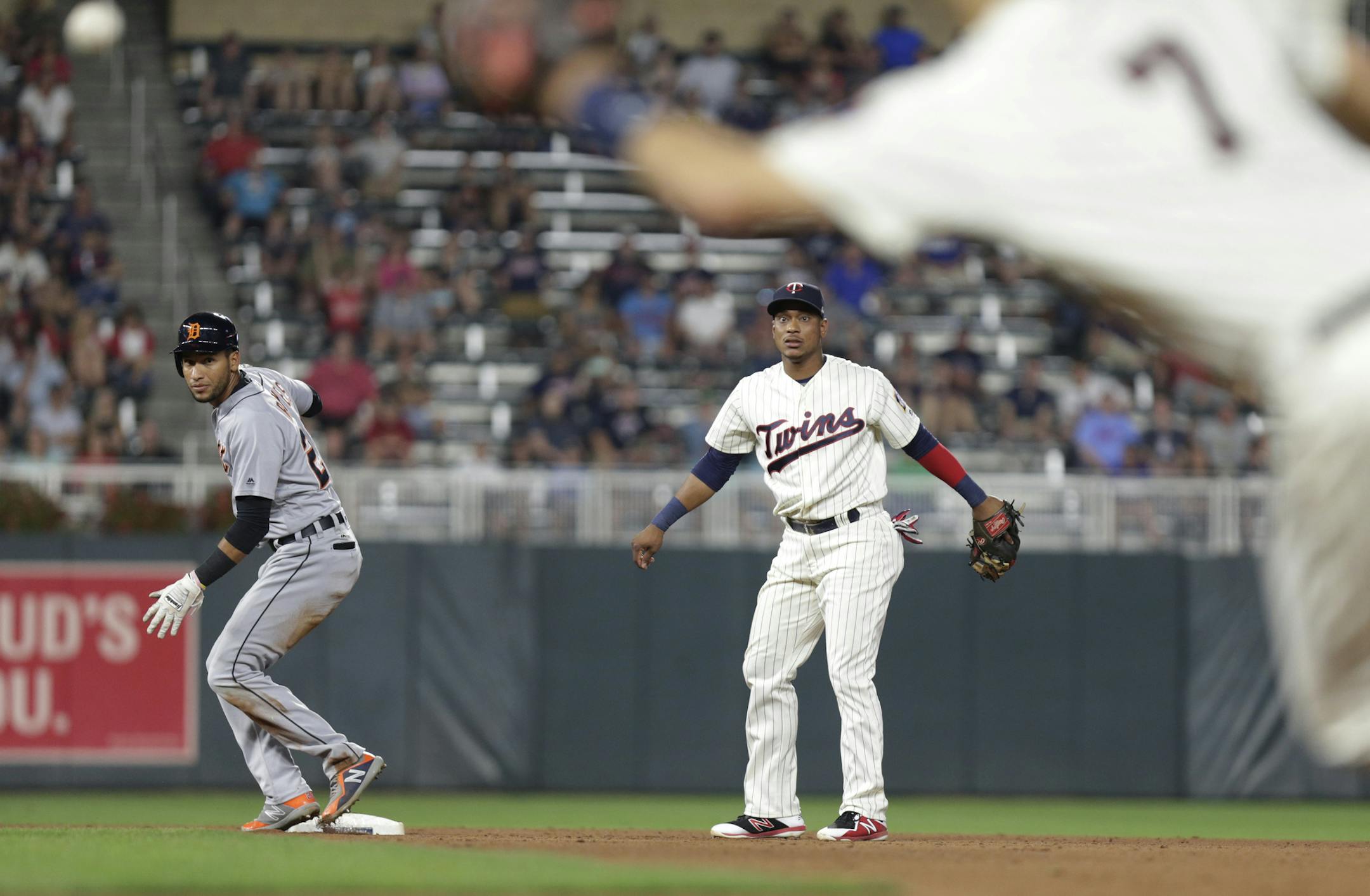 Minnesota Twins' Jorge Polanco, center, watches his throwing error to Twins' first baseman Joe Mauer (7) after getting Detroit Tigers' Victor Reyes, left, out on a fielder's choice but the throwing error caused a run to score home in the eighth inning during a baseball game Saturday, Aug. 18, 2018 in Minneapolis. (AP Photo/Andy Clayton-King)