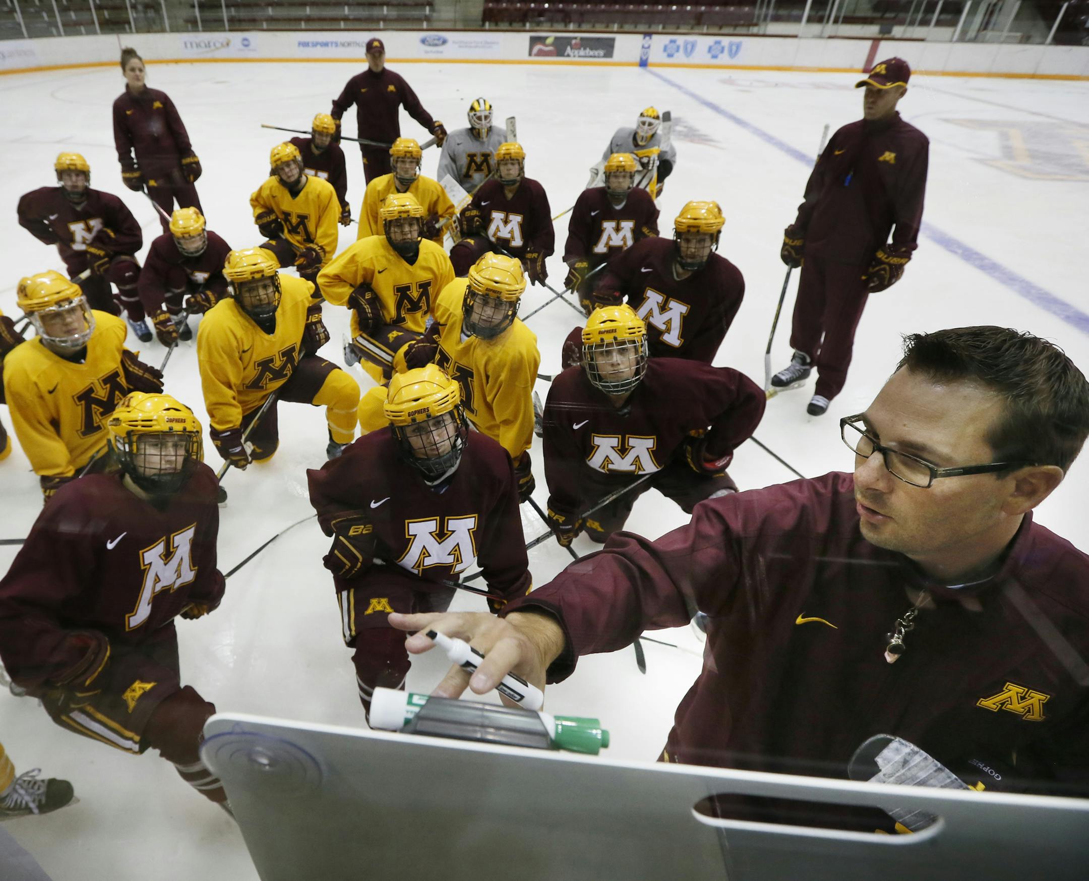 Minnesota coach Brad Frost go over plays with his team during practice.The University of Minnesota women's hockey team practiced Tuesday September 30 , 2014 at Ridder Arena in Minneapolis ,MN. ] Jerry Holt Jerry.holt@startribune.com