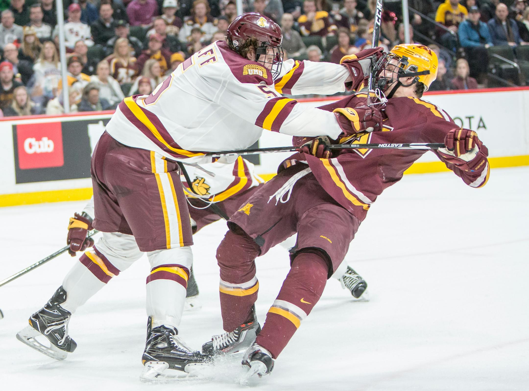 Minnesota Gophers forward Vinni Lettieri (19) is leveled in front of the net by UMD Bulldogs defenseman Nick Wolff (5). [ Special to Star Tribune, photo by Matt Blewett, Matte B Photography, matt@mattebphoto.com, January 27, 2017, Minnesota Golden Gophers, University of Minnesota Duluth (UMD) Bulldogs, North Star College Cup, Xcel Energy Center, St. Paul, Minnesota, SAXO 20046998A UPUK012817