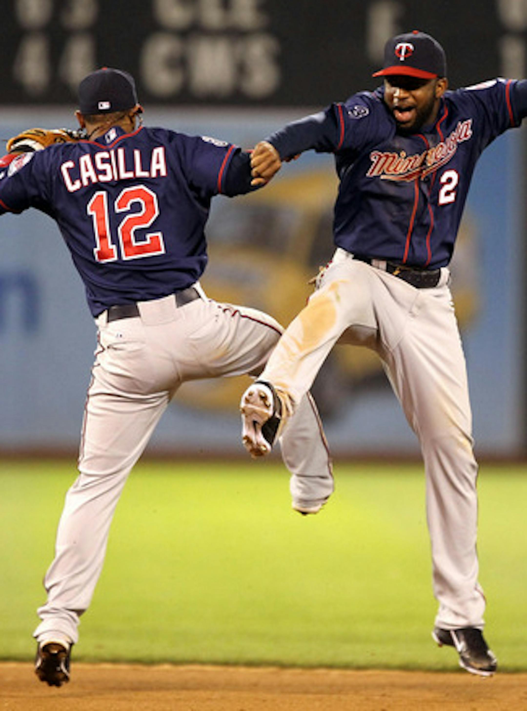 OAKLAND, CA - MAY 18:  Alexi Casilla #12 and Denard Span #2 of the Minnesota Twins celebrate after they beat the Oakland Athletics 4-3 in 10 innings at Oakland-Alameda County Coliseum on May 18, 2011 in Oakland, California.  (Photo by Ezra Shaw/Getty Images)