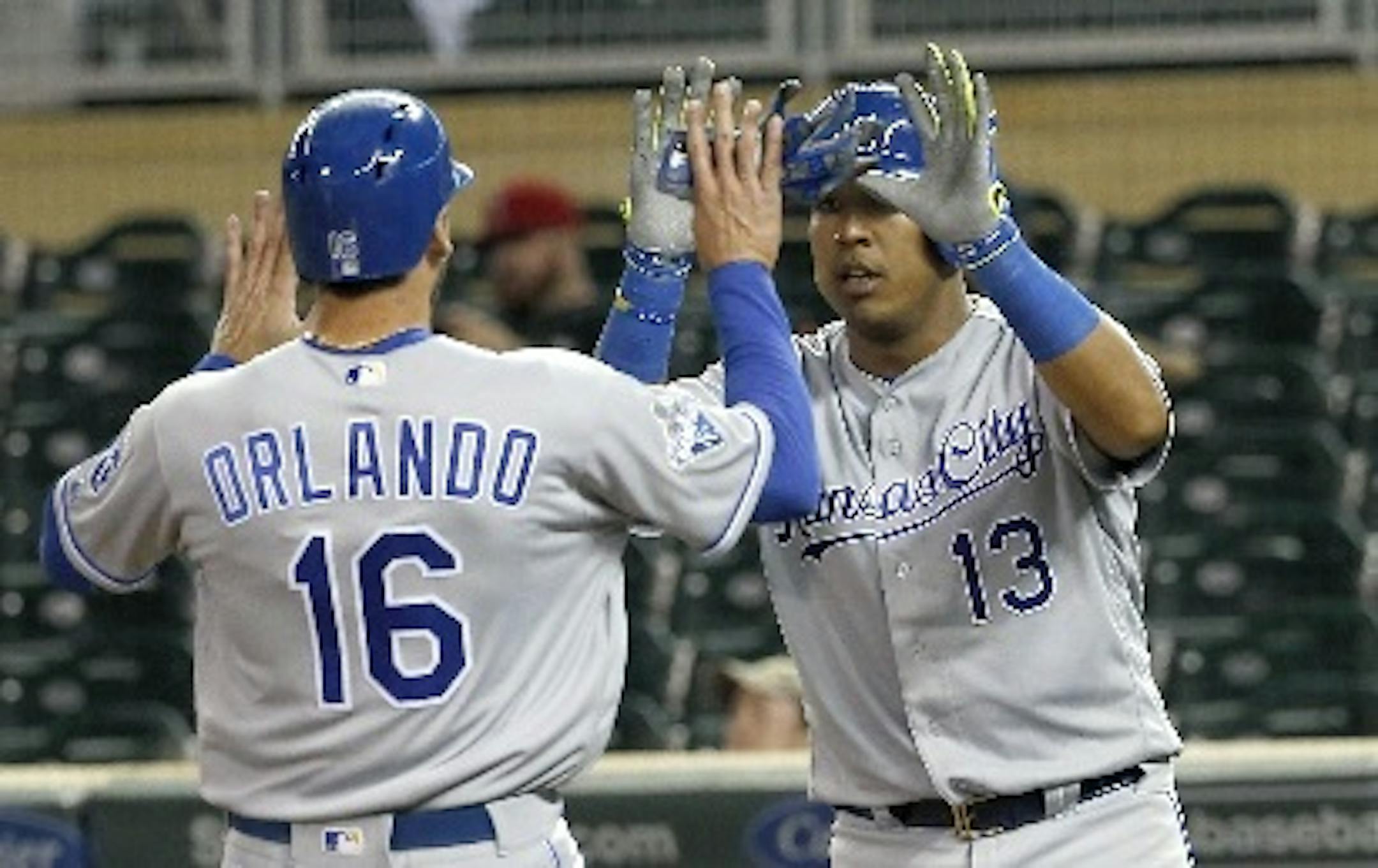 The Royals' Salvador Perez (13) and Paulo Orlando celebrated after scoring on a two-run double by teammate Omar Infante off Twins closer Kevin Jepsen during the ninth inning Monday.