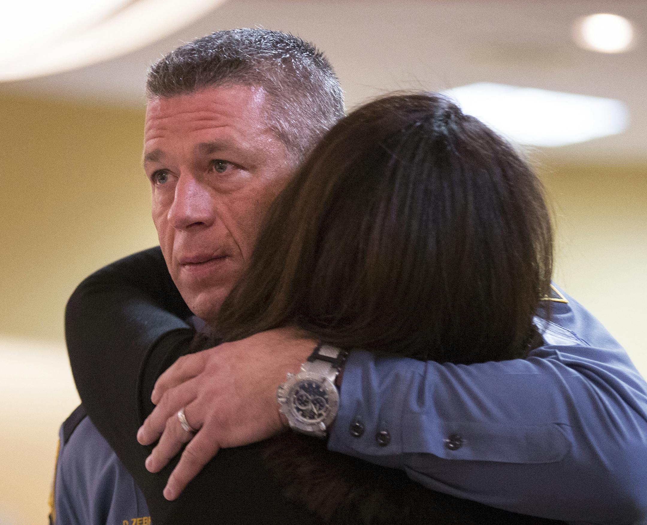 St. Paul detective of the year Sgt. Daniel Zebro hugs his wife Dena Zebro during the St. Paul Police Award Ceremony recognizing the officer, detective and civilian employees of the year at the Holiday Inn on Burns Avenue in St. Paul on Wednesday, April 8, 2015. ] LEILA NAVIDI leila.navidi@startribune.com /