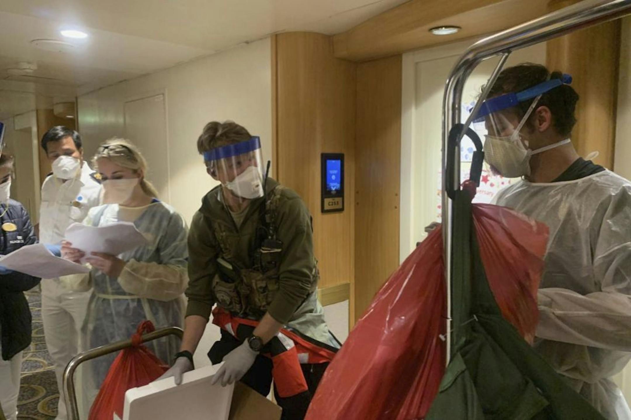 Medical personnel with the California Air National Guard's 129th Rescue Wing worked Thursday alongside staff from the Centers for Disease Control and Prevention, donning protective equipment after delivering virus testing kits to the Grand Princess cruise ship carrying more than 3,500 people off the coast of California.
