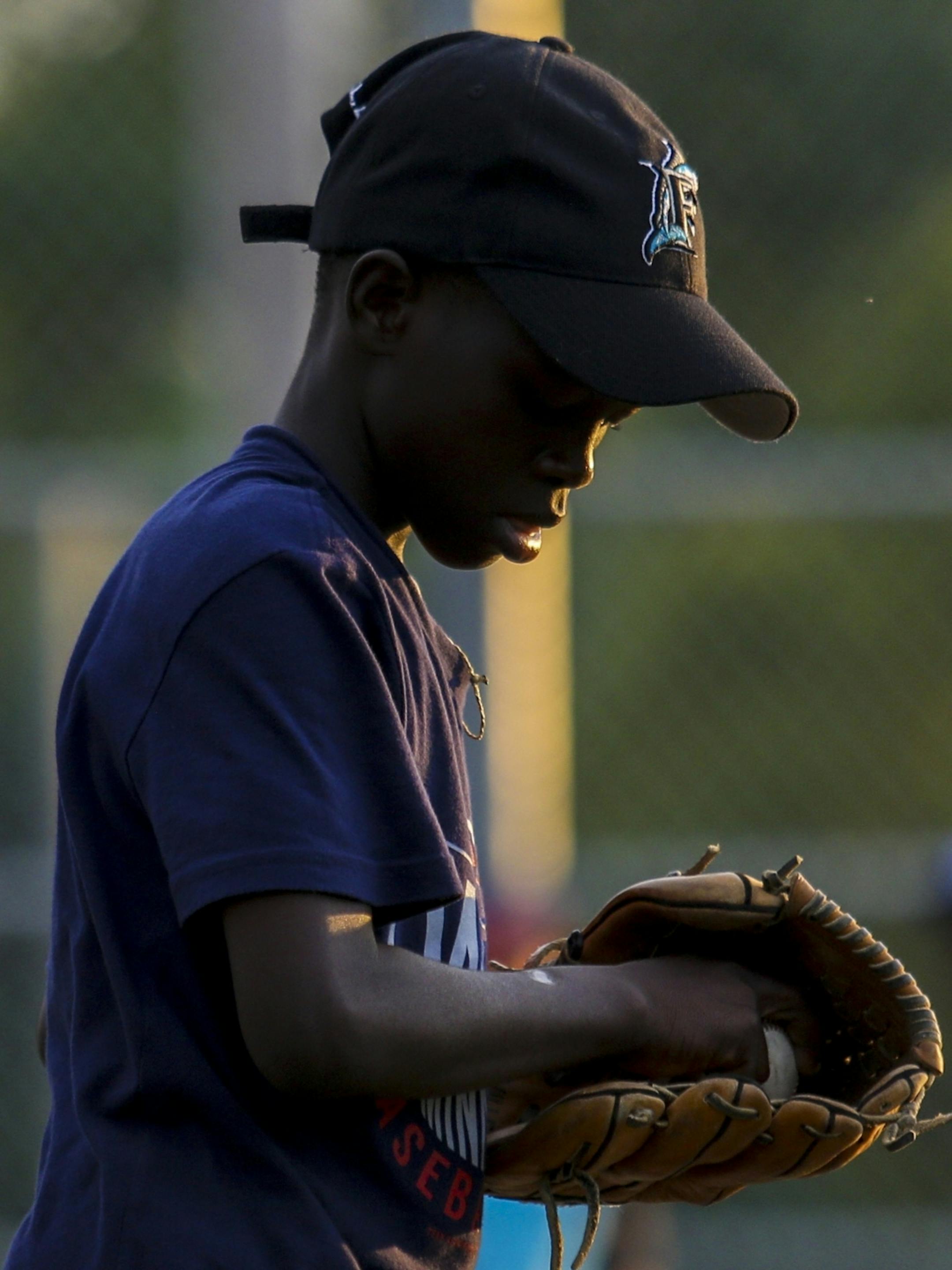 Bill Sagbo prepares to pitch during an evening practice at Lakeview Terrace Park on Monday, August 1, 2016 in Robbinsdale.