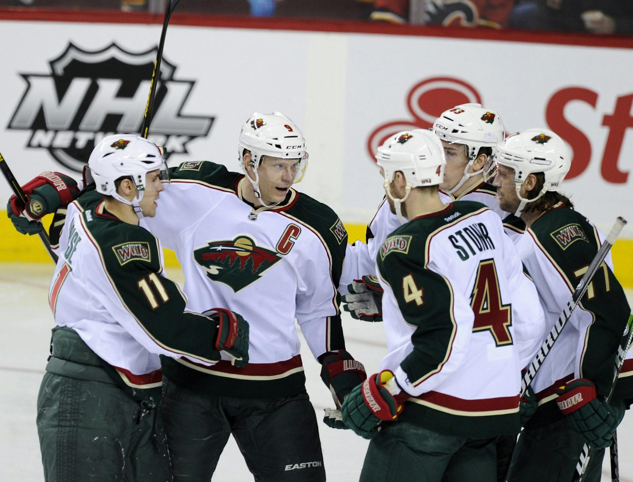 Wild captain Miiko Koivu celebrated his first-period goal against Calgary with teammates Zach Parise (11), Clayton Stoner (4), Charlie Coyle and Tom Gilbert (77). The Wild led 4-1 five minutes into the third period and held on for a 4-3 victory.