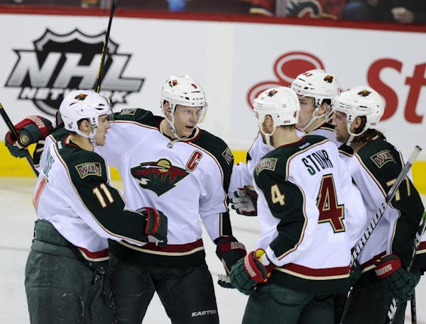Wild captain Miiko Koivu celebrated his first-period goal against Calgary with teammates Zach Parise (11), Clayton Stoner (4), Charlie Coyle and Tom G