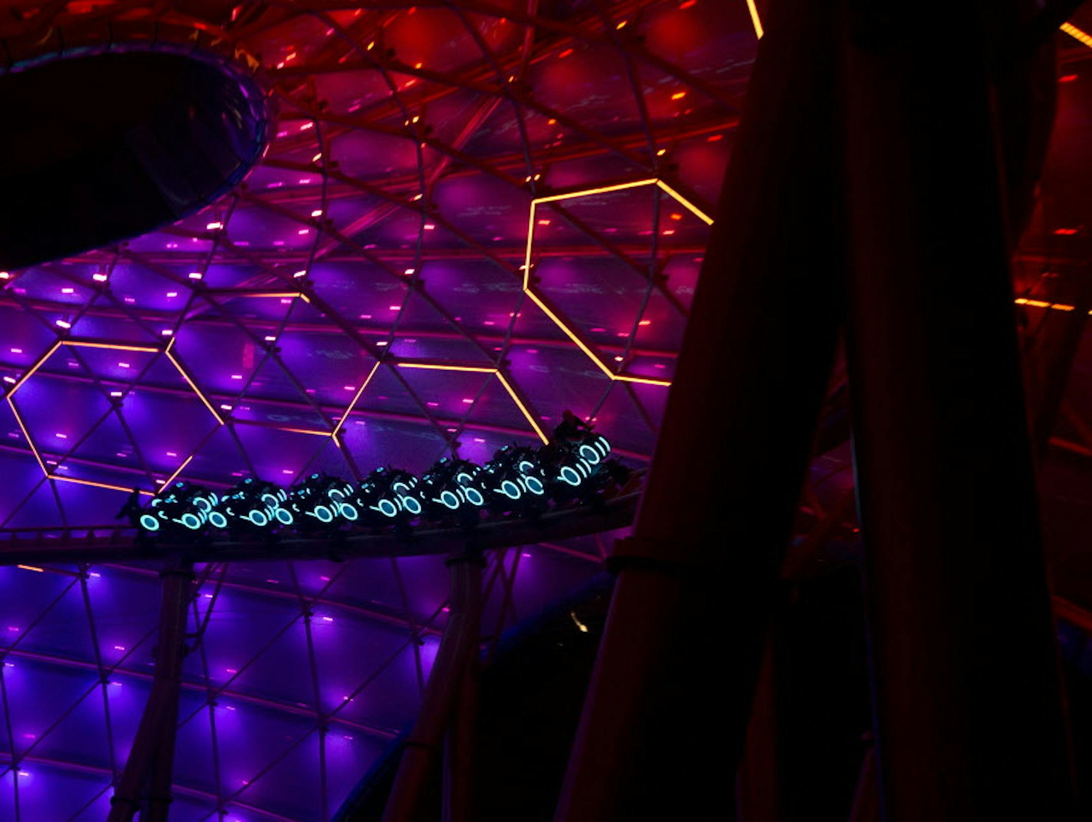 Visitors enjoy the TRON Lightcycle Power Run ride, which is based on Disney's TRON franchise, at the Disney Resort on the eve of its grand opening in Shanghai, China, Wednesday, June 15, 2016. Analysts expect Shanghai Disneyland to become the world's most-visited theme park, attracting up to 50 million guests a year, compared with 19.3 million people for Disney's flagship Walt Disney World in Orlando, Florida, in 2014.(AP Photo/Ng Han Guan)