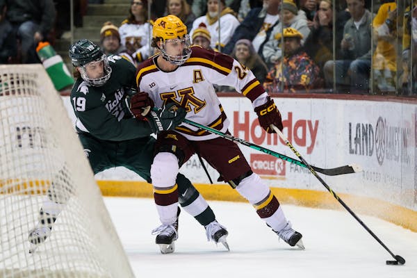 Gophers forward Jaxon Nelson worked around the net on Saturday against Michigan State in the Big Ten tournament semifinals at Mariucci Arena.