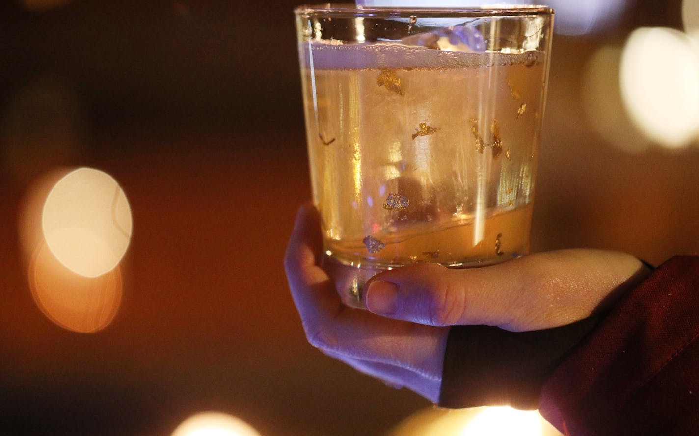 A patron held a yukon cornelius drink with flakes of silver and gold at Hewing Hotel's rooftop ice bar. ] ANTHONY SOUFFLE &#xef; anthony.souffle@startribune.com Hewing Hotel held an opening event for their ice bar on the rooftop Friday, Dec. 22, 2017 in Minneapolis.