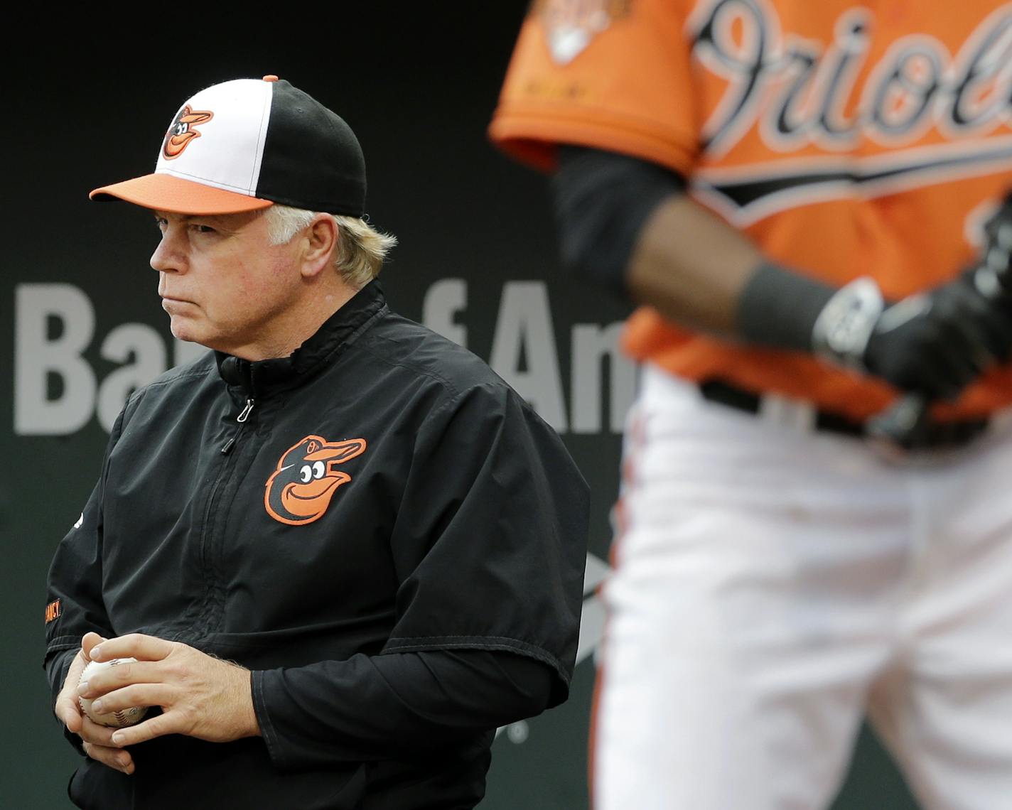 Baltimore Orioles manager Buck Showalter watches from the dugout as Alejandro De Aza, front right, prepares for an at-bat in the ninth inning of a baseball game against the New York Yankees, Saturday, Sept. 13, 2014, in Baltimore. New York won 3-2. (AP Photo/Patrick Semansky)