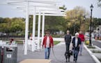 Michael and Carol Allen of Plymouth walked along Wayzata's new lakeside plaza with their dog Tug. The couple was out walking to celebrate Carl's birth
