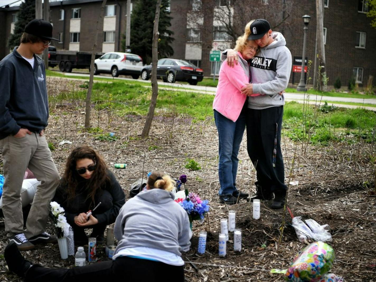 Ryan Reeves mother Tracy Reeves and younger brother Calvin hugged at the spor where Reeves died. Family members of Ryan Reeves, 32, who died after his car hit a tree at the end of a police chase, gathered here at the place where he died near the corner of Hamline Ave N and Wynne Ave.St. Paul.